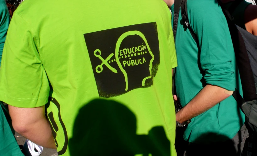 a group of young men with green shirts