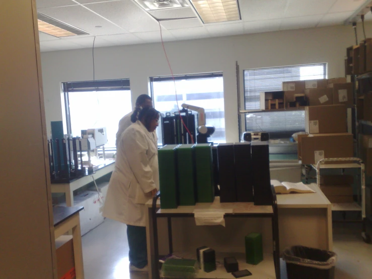 a lab technician looks at materials on a table