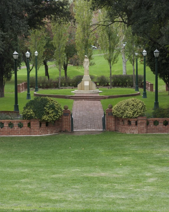 a statue that is standing in the grass