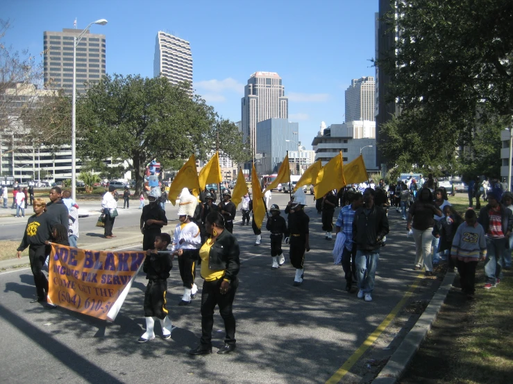 a demonstration in the street with several people holding signs