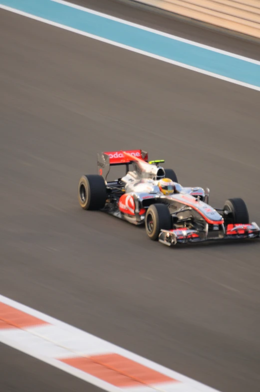 a white and red race car on a race track