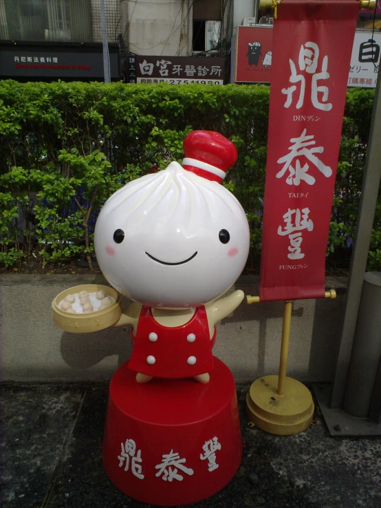 the statue is holding a bowl with rice in it