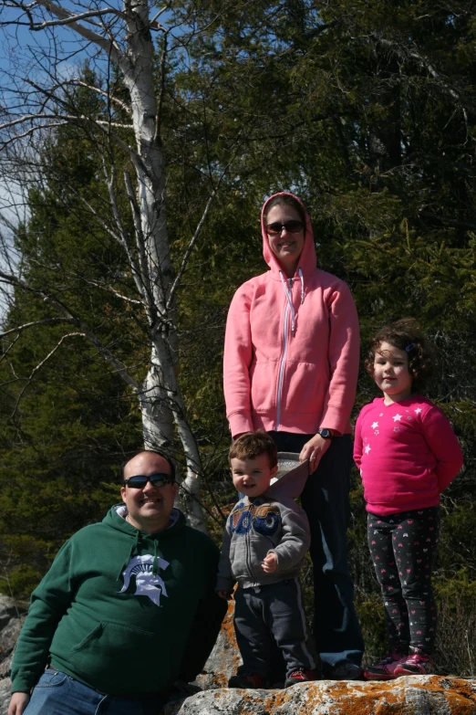 a family poses for a po on a sunny day