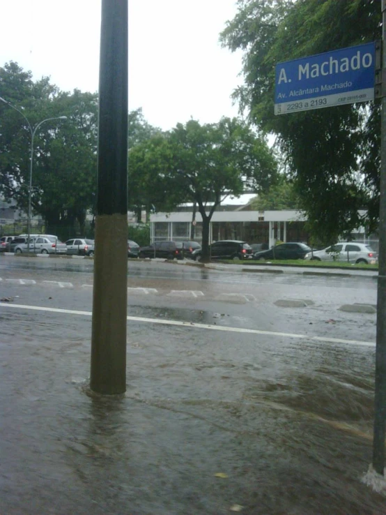 a building is in the water with cars parked outside