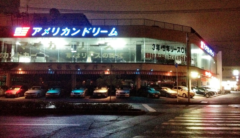 the exterior of a japanese restaurant with neon lights
