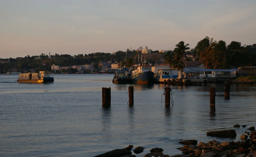 the boats are sailing in the lake near the shoreline