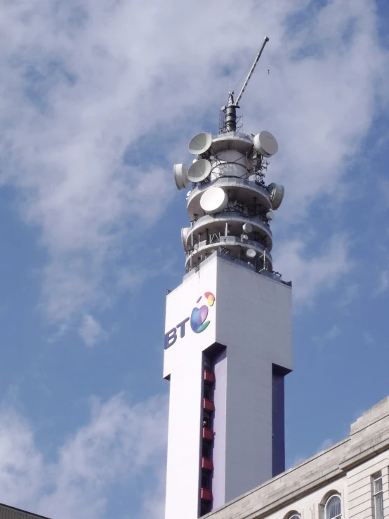 the tall tower is adorned with a radio device