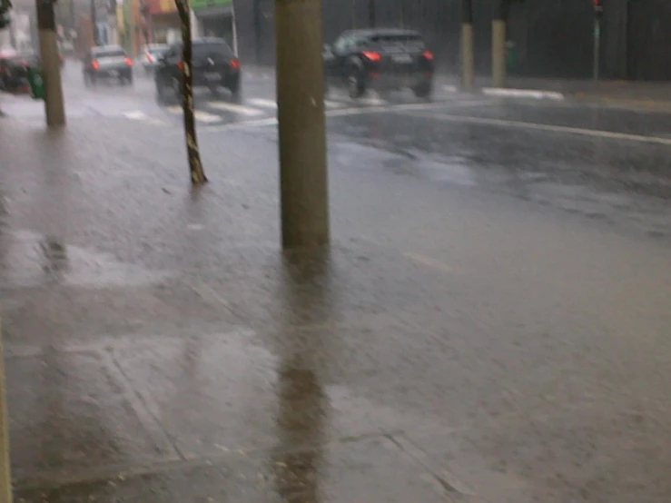 people walking down the street in the rain with umbrellas