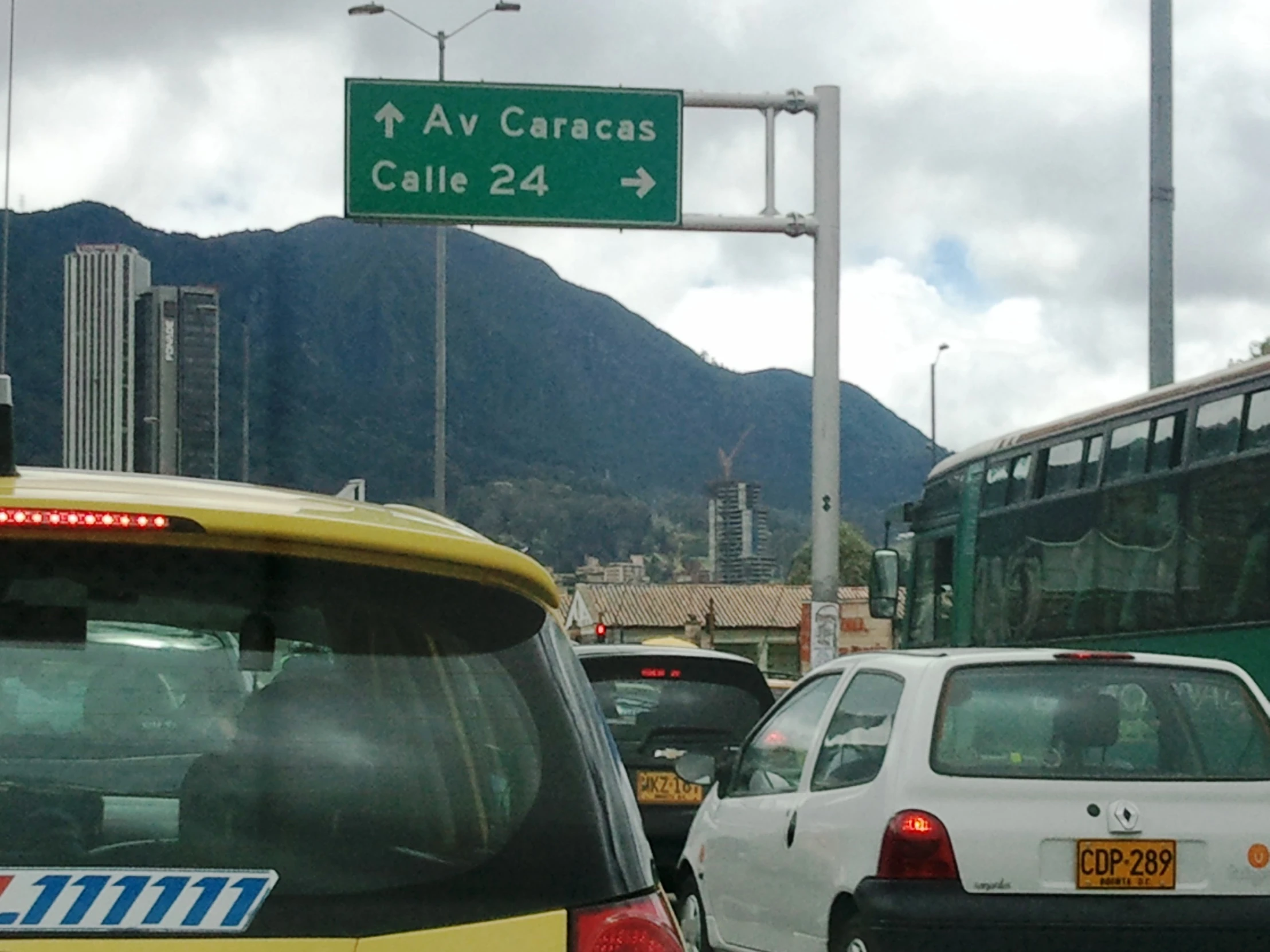 a city bus is going down the busy street