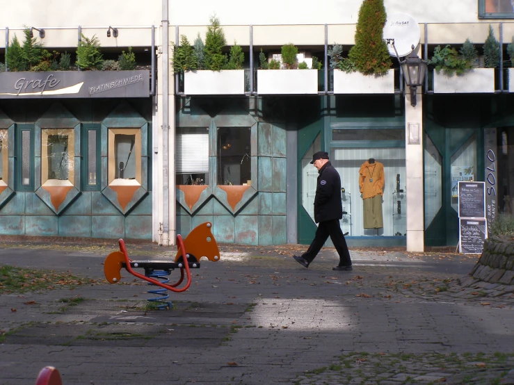 a person walking down a road next to an upside down play area