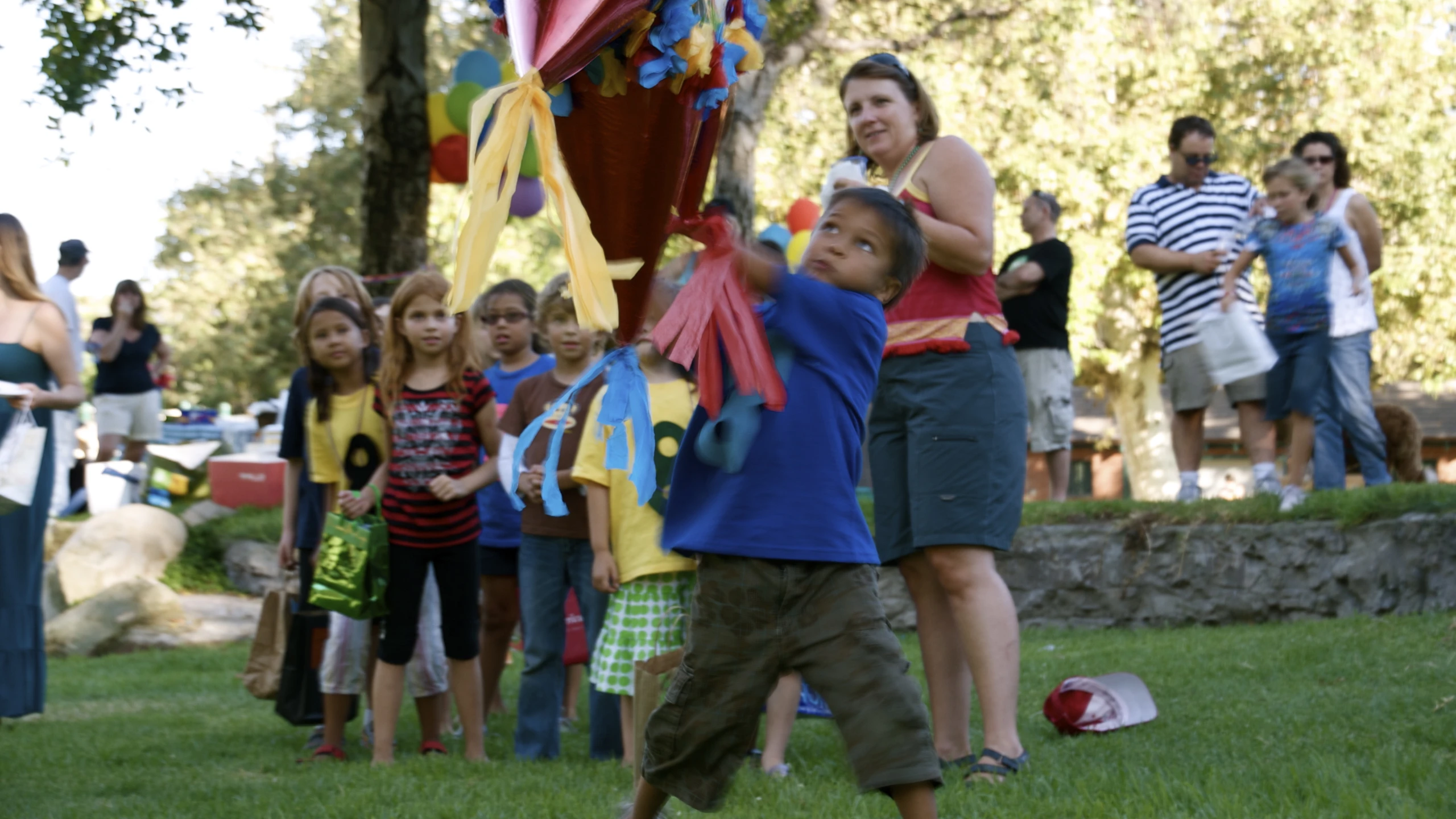 children play with toys while others watch at the park