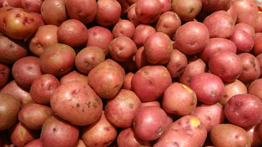 many different types of potatoes are piled on top of each other