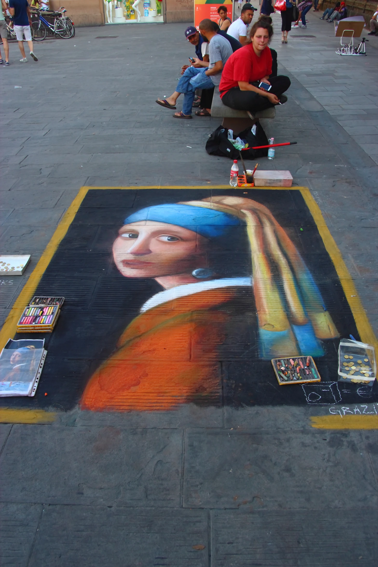 a  riding a skate board next to a portrait of a man on the sidewalk