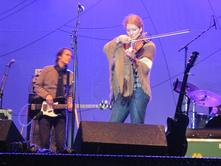 an image of a man and woman playing instruments