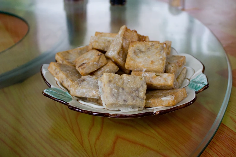 some breaded tofu on a white and brown dish