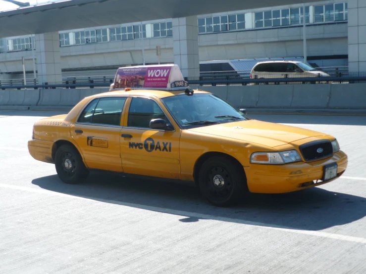 a taxi cab with its lights on in a parking lot