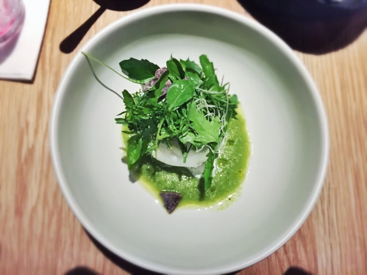 a plate with a small bowl of salad