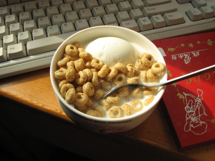 a bowl of cereal and ice cream on a desk