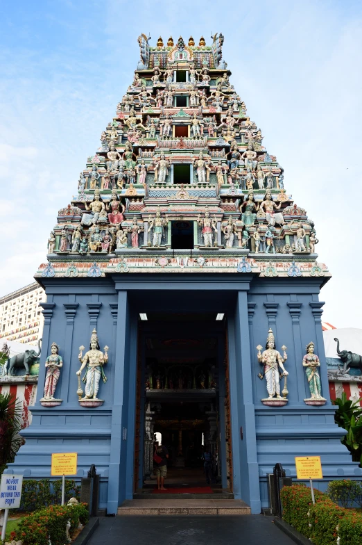 an outdoor temple structure with many statues and decorations