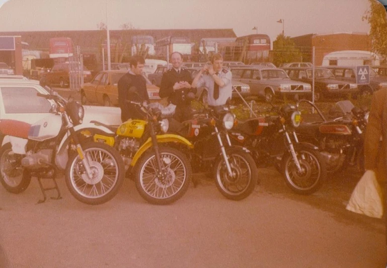 several motorcycles parked next to one another in a parking lot