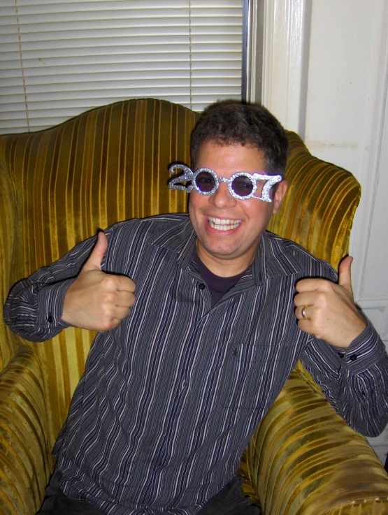 a man is smiling and has white glasses