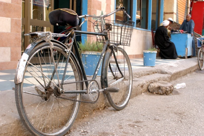 a couple of bikes sit on the sidewalk