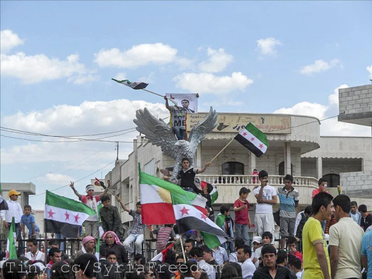 a large group of people watching flags fly