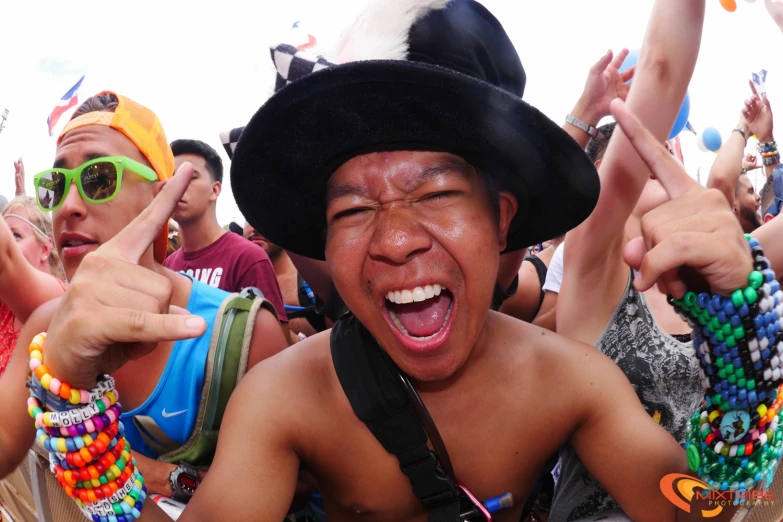 the crowd at an outdoor music festival has a goofy face