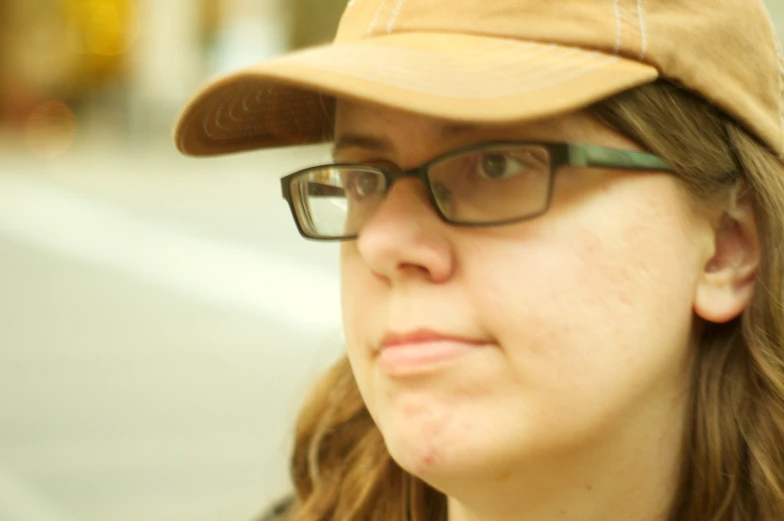 a lady that is wearing a cap and glasses