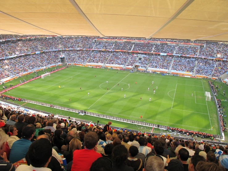 the crowd is watching an indoor soccer game