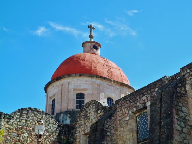 the top of an old church against a clear blue sky