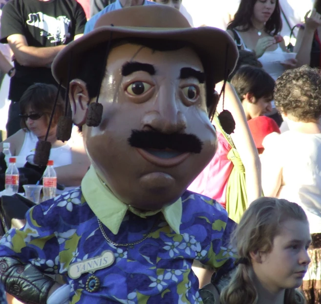 the large man is wearing a silly hat and a flowery shirt