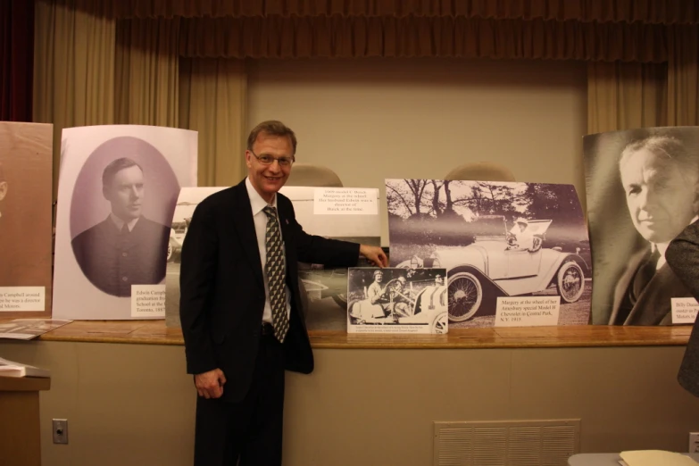 there is a man in a suit standing in front of some signs