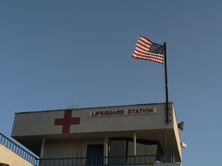 an american flag on top of a lifeguard station