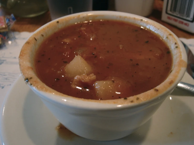 a white bowl filled with soup sitting on top of a table