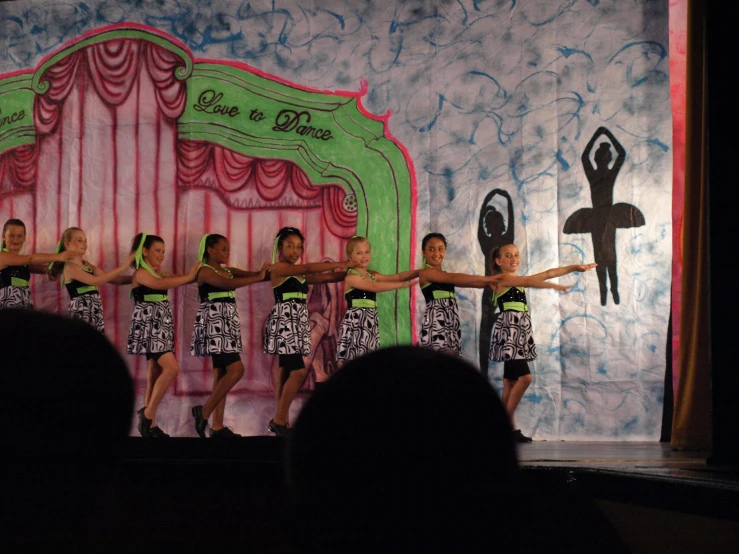 a group of young women are performing on stage