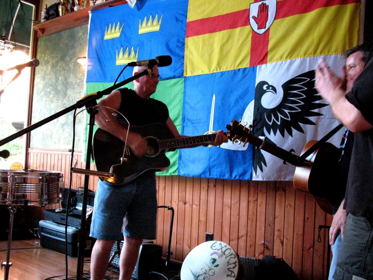 a man standing on stage playing guitar