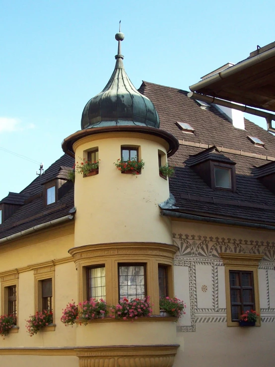 a large building with a tower with windows and shutters