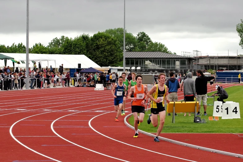 people in the background at a race track with one person running