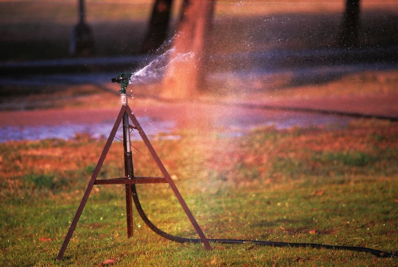 a small sprinkle is set on top of a garden hose