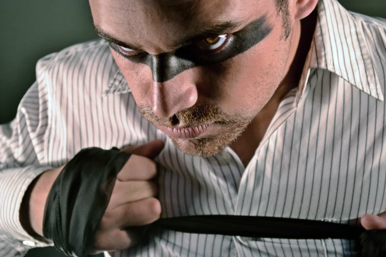 a man in striped shirt tie and makeup