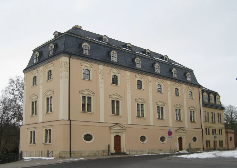 a building on the corner of the street with several stories