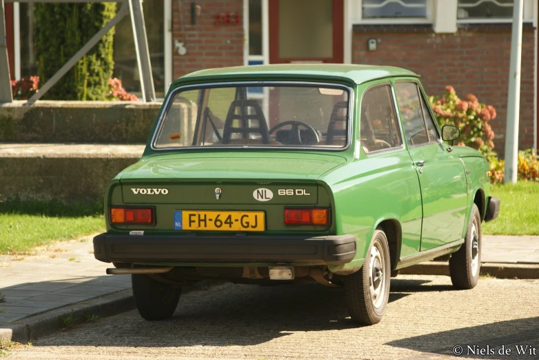 a green small car parked on the street