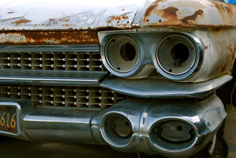 a rusted car's front bumper and exhaust pipe