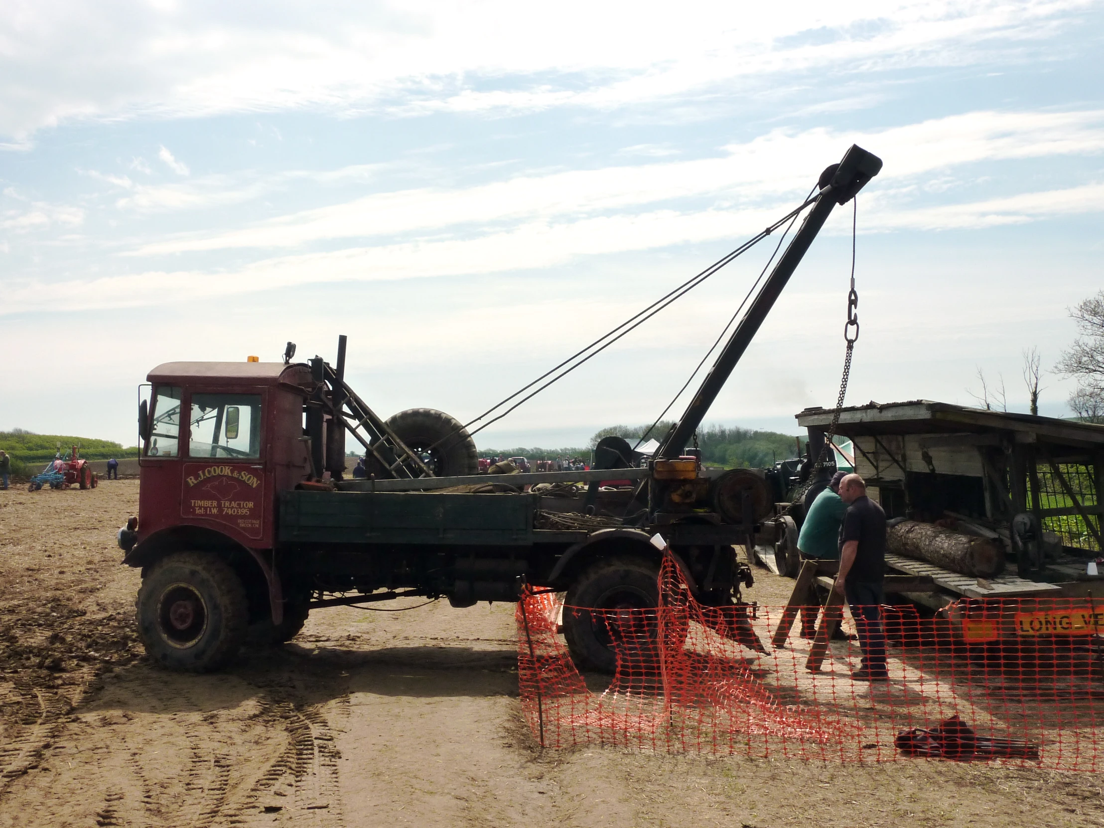 a tow truck carrying a piece of equipment to its destination