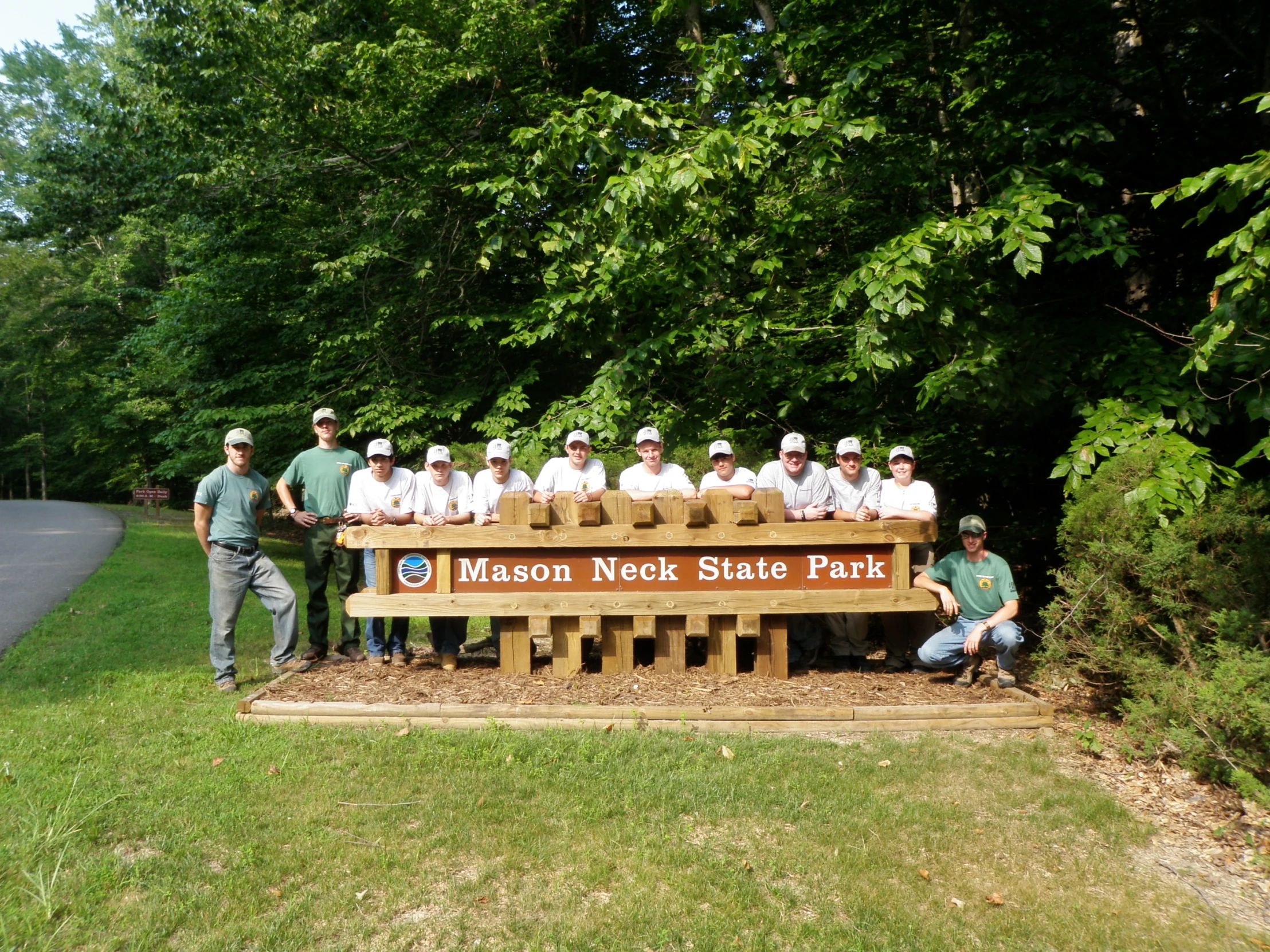 a group of men holding onto a large bench