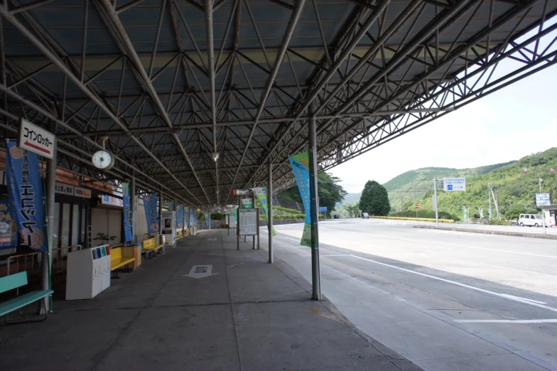 the walkway under a metal structure has advertits on it