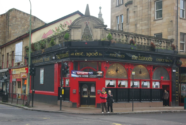 two people stand outside an old fashion bar