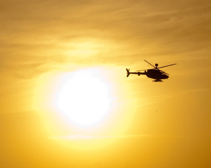 a helicopter flying high up in the sky