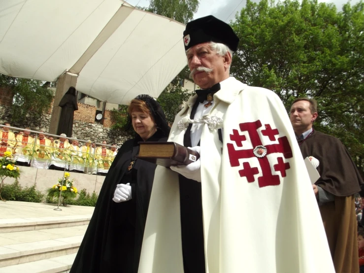 a priest is standing next to the woman